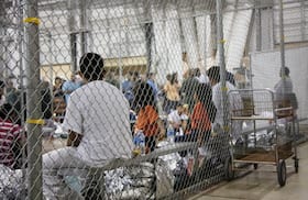 Migrants taken into custody for illegal entry at the U.S.-Mexico border in 2018 are confined at a facility in McAllen, Texas. (U.S. Customs and Border Protection/AP)