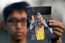 Harrison Li holds a photo of his father, Kai Li, in 2023.