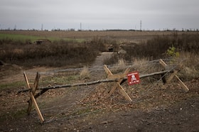 A sign warns of land mines in Ukraine's Kherson region in 2023. (Ed Ram for The Washington Post)