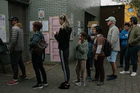 Voters wait in line to vote outside a polling site in Philadelphia on Tuesday. (Caroline Gutman for The Washington Post)