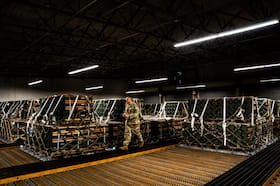 An airman checks the paperwork of pallets of ammunition, weapons and other equipment bound for Ukraine at a storage bunker at Dover Air Force Base in Delaware in 2022.