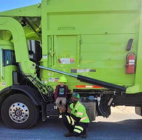 John Coleman with garbage truck driver Craig Hodges. About 10 months ago, John brought Hodges an apple, and they became friends.